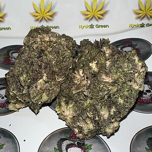 Dense cannabis buds with purple and green hues, high-quality flower for sale.